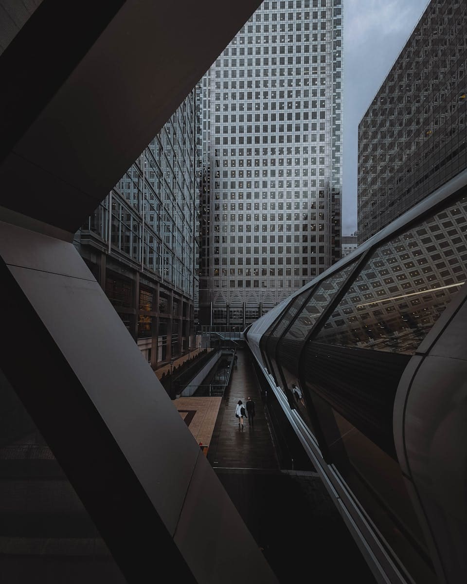 Dramatic view of modern skyscrapers in London's financial district hosting fintech consulting for governments.