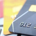 High-quality close-up of bank cards, highlighting small EMI license v full EMI license